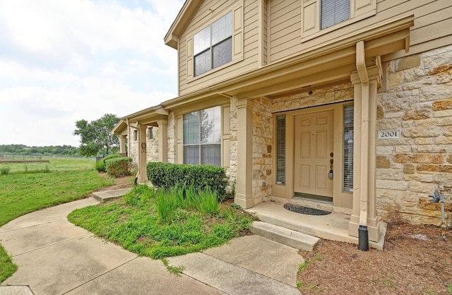 view of exterior entry featuring stone siding