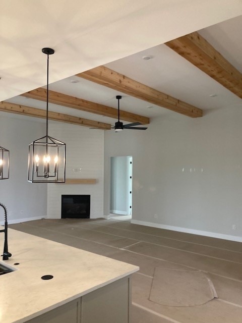 216 Cherry Sage Ct, Dripping Springs, TX 78620 - unfurnished living room with a fireplace, baseboards, and beamed ceiling