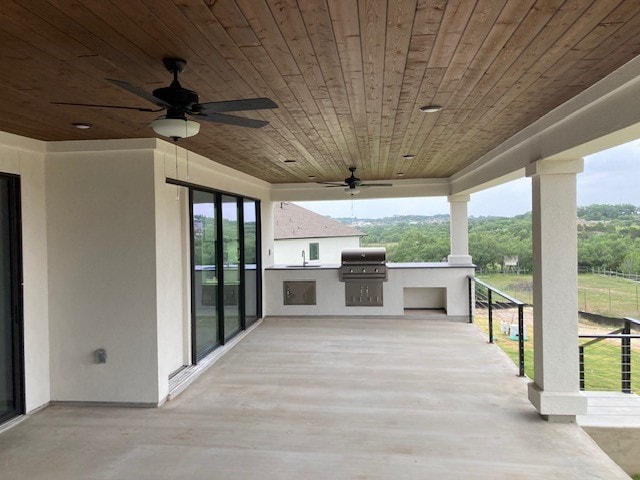 216 Cherry Sage Ct, Dripping Springs, TX 78620 - wooden deck with ceiling fan, an outdoor kitchen, and a grill