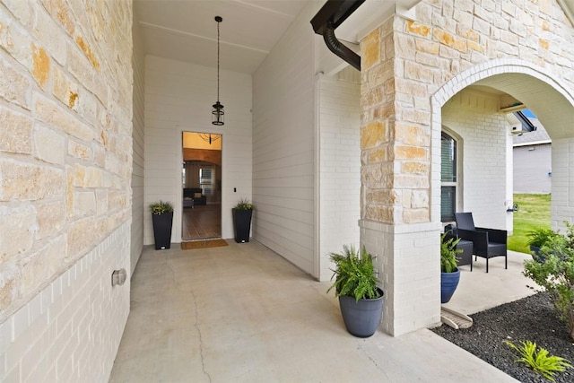 entrance to property with brick siding and stone siding