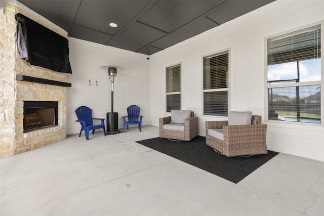 view of patio with an outdoor stone fireplace
