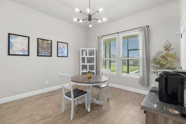 dining space with baseboards, light wood finished floors, and a chandelier