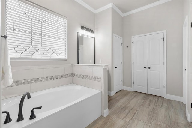 bathroom featuring crown molding, baseboards, and a garden tub