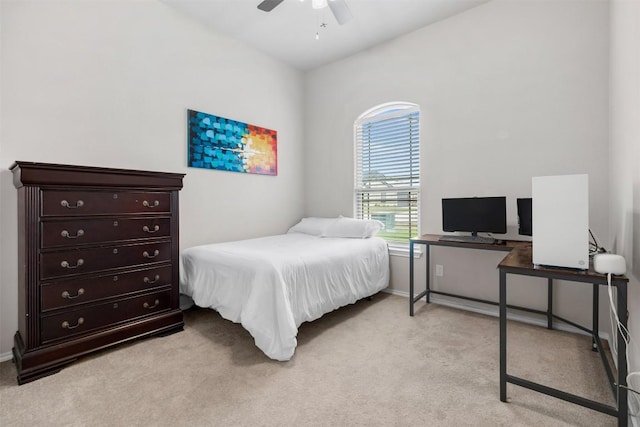 bedroom with light colored carpet, a ceiling fan, and baseboards
