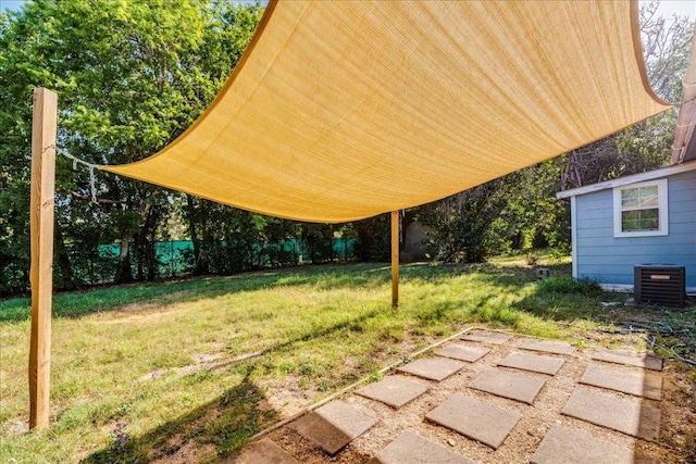 view of yard with fence and cooling unit