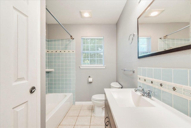 bathroom with shower / washtub combination, tile patterned floors, baseboards, vanity, and toilet