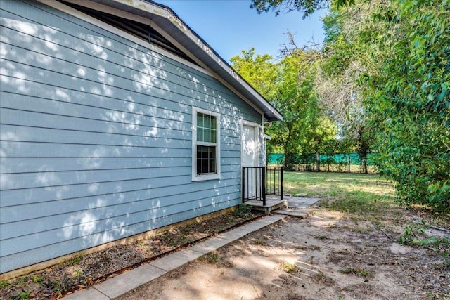 view of property exterior featuring fence