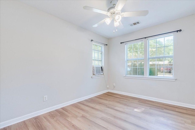 unfurnished room featuring baseboards, a ceiling fan, light wood-type flooring, and visible vents