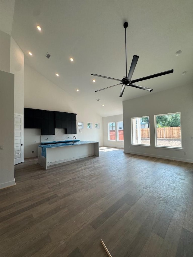 1410 Cardinal Ln, Round Rock, TX 78681 - unfurnished living room with a sink, a ceiling fan, wood finished floors, high vaulted ceiling, and recessed lighting