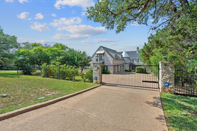 view of gate featuring a lawn and fence private yard