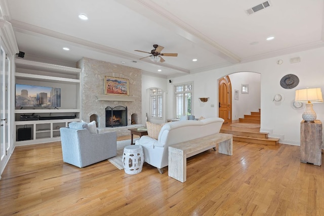 living room featuring a ceiling fan, beamed ceiling, visible vents, and light wood-type flooring