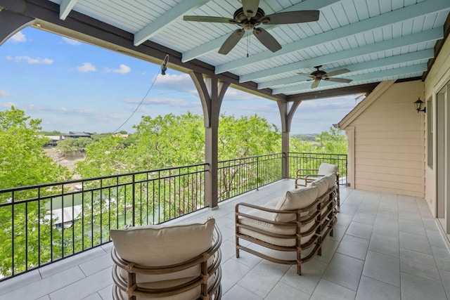 view of patio / terrace with ceiling fan and a balcony