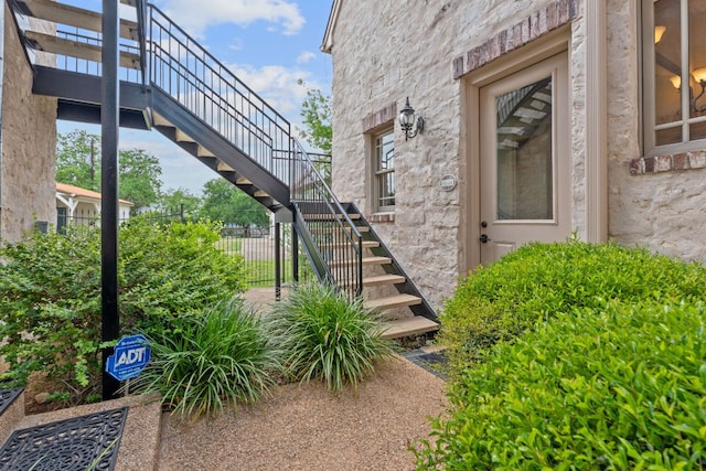 doorway to property featuring fence