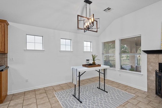 office with a wealth of natural light, a fireplace, a notable chandelier, and visible vents