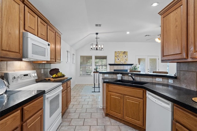 kitchen with a sink, decorative backsplash, brown cabinets, and white appliances