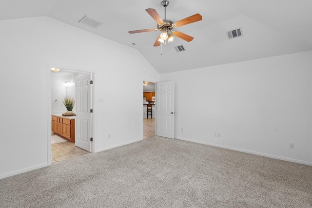 unfurnished bedroom featuring baseboards, visible vents, light carpet, and lofted ceiling