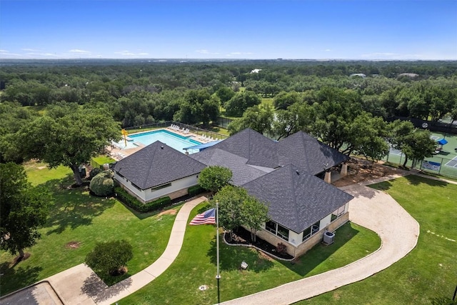 bird's eye view with a wooded view