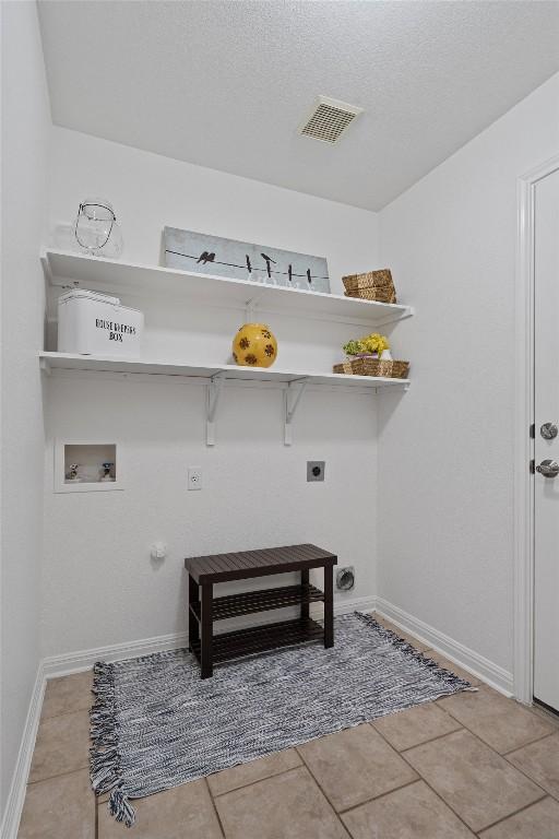 laundry area featuring laundry area, visible vents, baseboards, hookup for a washing machine, and hookup for an electric dryer