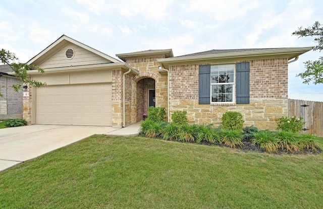 single story home with a garage, fence, a front yard, stone siding, and concrete driveway