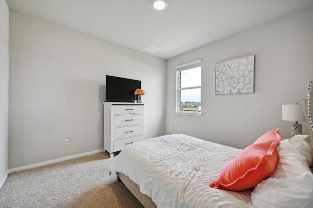 carpeted bedroom featuring baseboards and visible vents