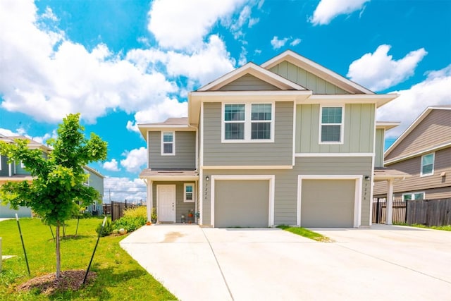 craftsman house with fence, concrete driveway, a garage, a front lawn, and board and batten siding