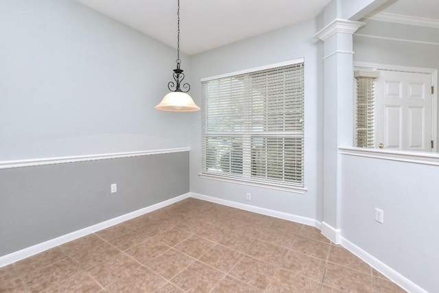 unfurnished dining area with tile patterned floors, baseboards, and ornate columns