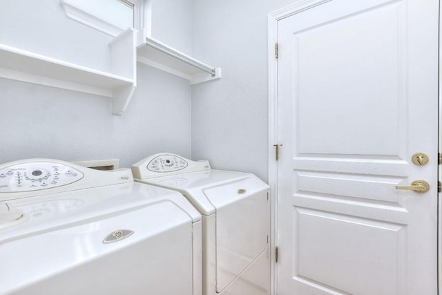 laundry room with washing machine and clothes dryer and laundry area