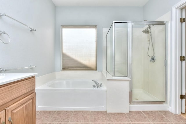full bath featuring vanity, a bath, a stall shower, and tile patterned floors