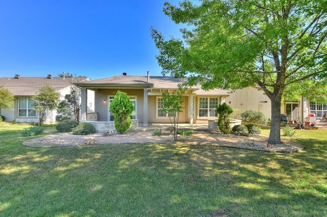 ranch-style house with stucco siding and a front yard