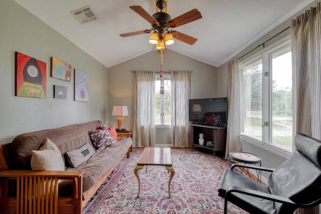 living room featuring visible vents, lofted ceiling, and a healthy amount of sunlight
