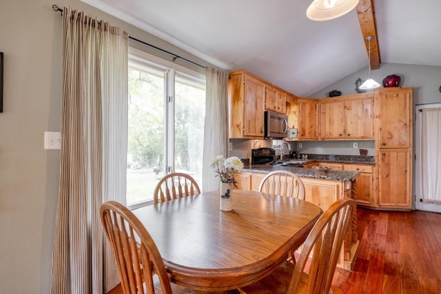 dining area featuring lofted ceiling with beams and hardwood / wood-style floors