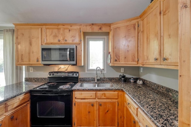 kitchen featuring a sink, dark stone counters, stainless steel microwave, and black / electric stove