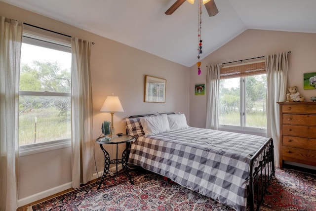 bedroom with baseboards, ceiling fan, and vaulted ceiling