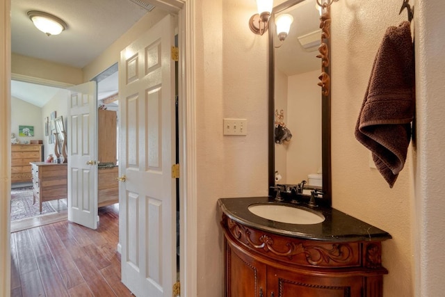 half bath featuring vanity and wood finished floors