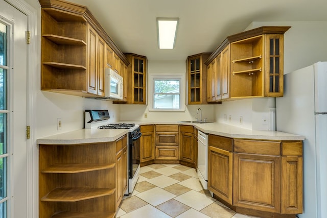 8504 Burrell Dr, Austin, TX 78757 - kitchen featuring open shelves, white appliances, brown cabinets, light countertops, and light tile patterned flooring