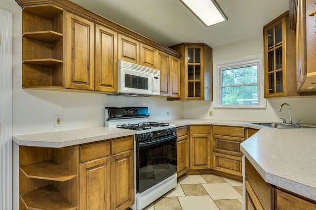 8504 Burrell Dr, Austin, TX 78757 - kitchen with open shelves, gas stove, white microwave, and brown cabinets