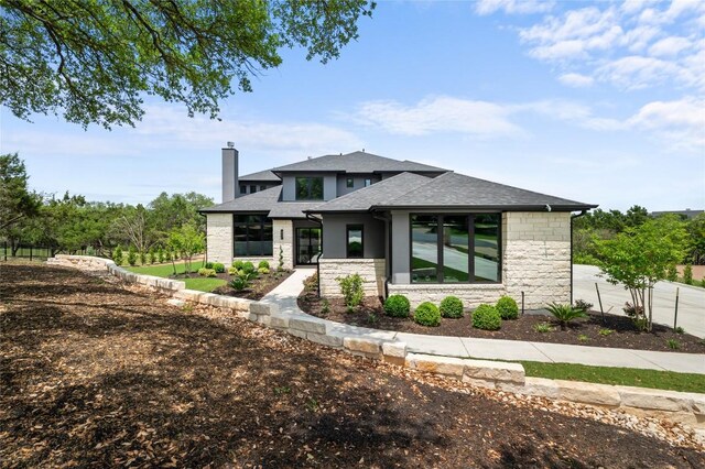 3202 Winding Creek Cv, Austin, TX 78735 - view of front of house featuring stone siding, a chimney, and roof with shingles