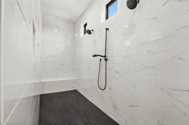 full bath with a tile shower