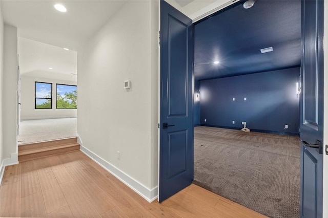 corridor featuring baseboards, recessed lighting, and wood finished floors