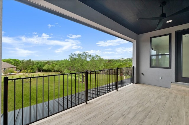 deck with a yard and ceiling fan