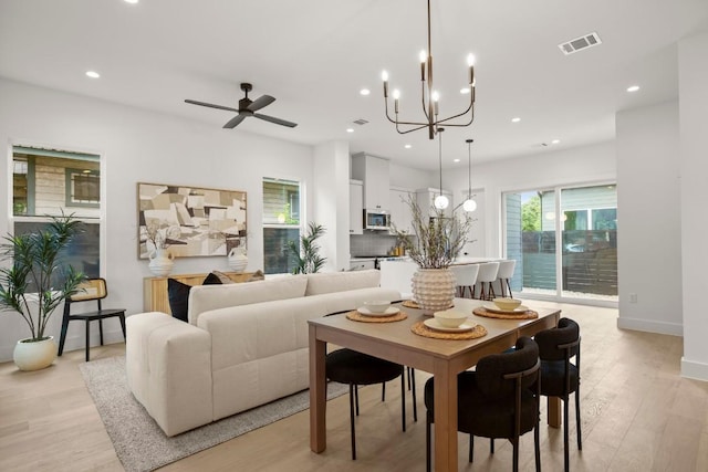 6110 Atwood St Unit 1, Austin, TX 78741 - dining area featuring ceiling fan with notable chandelier, recessed lighting, light wood-style flooring, and visible vents