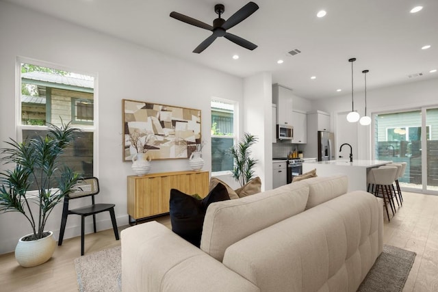 6110 Atwood St Unit 1, Austin, TX 78741 - living room with ceiling fan, light wood-type flooring, recessed lighting, and visible vents