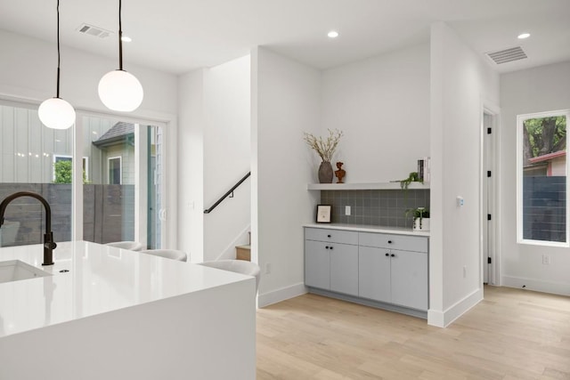 6110 Atwood St Unit 1, Austin, TX 78741 - bar with backsplash, recessed lighting, visible vents, and light wood-style floors