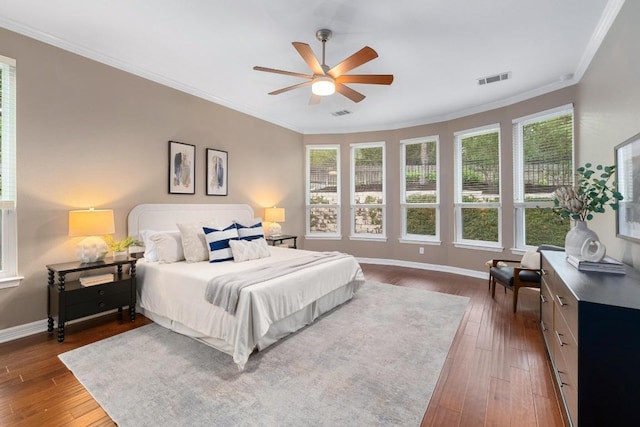 bedroom with a ceiling fan, visible vents, crown molding, baseboards, and dark wood-style floors