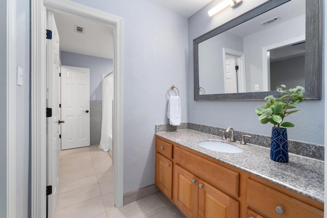 bathroom featuring visible vents, a shower with shower curtain, tile patterned flooring, and vanity