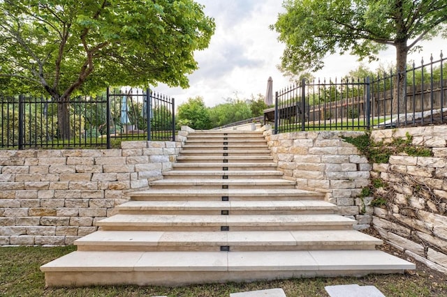 exterior space with fence and stairs