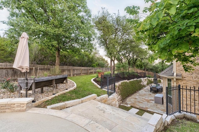 view of yard featuring a fenced backyard and a patio area