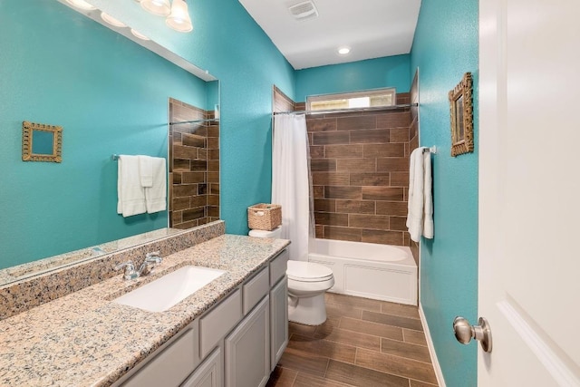 2229 Sauterne Dr, Leander, TX 78641 - bathroom with vanity, toilet, shower / tub combo, wood tiled floor, and visible vents