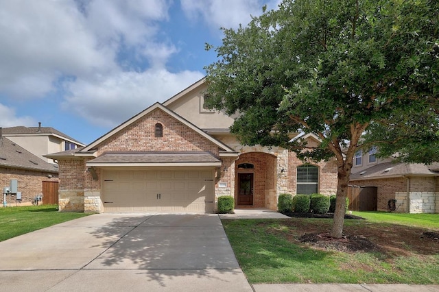 2229 Sauterne Dr, Leander, TX 78641 - view of front of property featuring a front yard, a garage, brick siding, concrete driveway, and stone siding