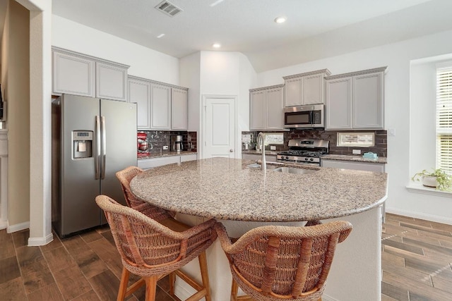 2229 Sauterne Dr, Leander, TX 78641 - kitchen featuring gray cabinets, visible vents, baseboards, stainless steel appliances, and dark wood-type flooring